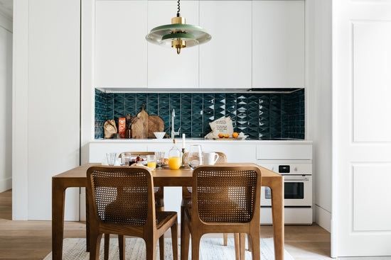 Modern two-bedroom apartment in neutral tones with minimalist design, featuring elegant furnishings and natural light in a spacious Portuguese urban setting.