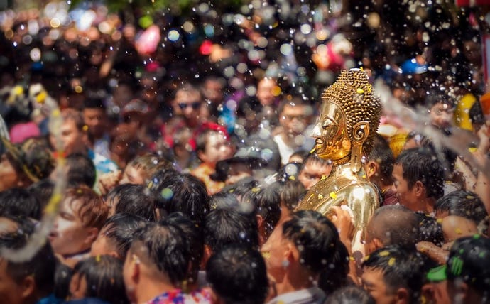 A Buddha statue calmly taking part in the Songkran festival