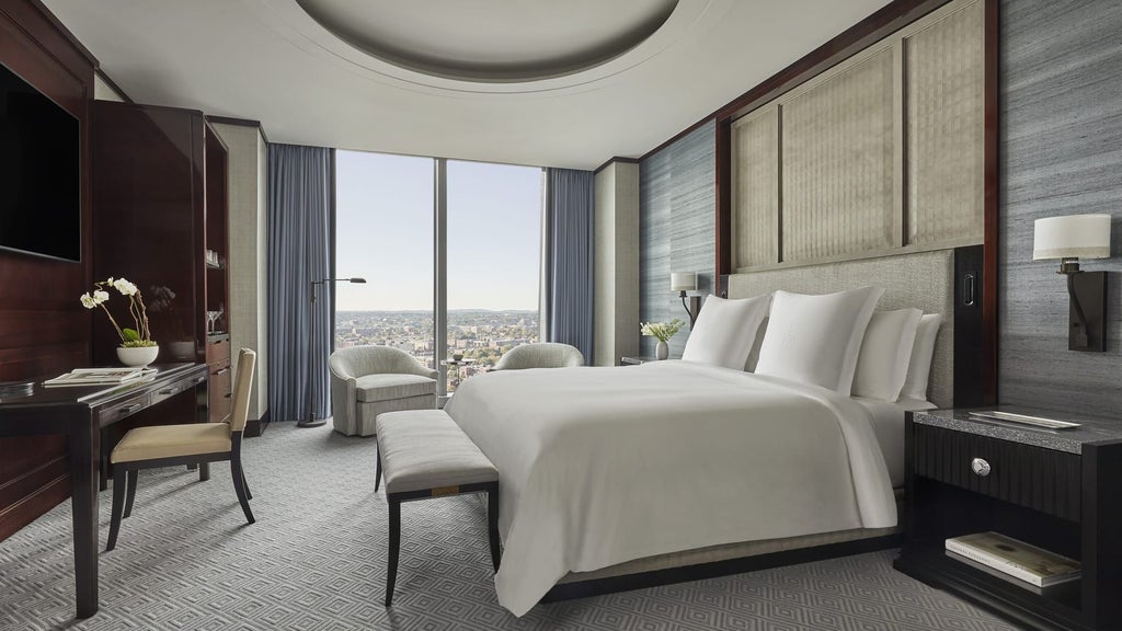 Opulent presidential suite at [Hotel Location] with panoramic city views, elegant king bed, plush seating, marble bathroom, and sophisticated contemporary design