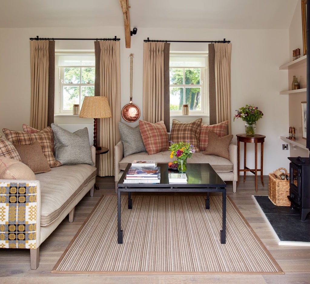 Elegant boutique hotel room with plush white bedding, rustic wooden headboard, soft neutral tones, and luxurious textured throws at Grove of Narberth