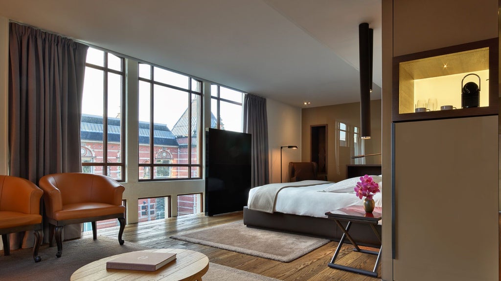 Luxurious Grand Junior Suite with modern Dutch design, featuring elegant neutral tones, expansive windows, and sophisticated minimalist furnishings