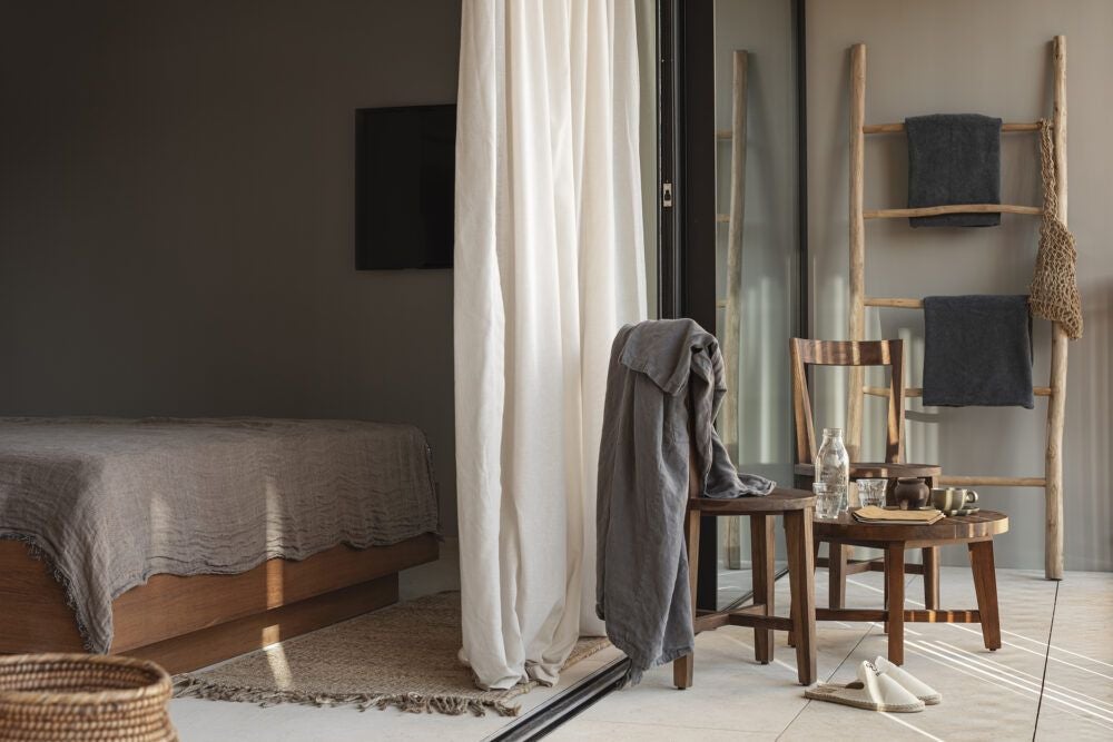 Luxurious white-themed junior suite with minimalist design, featuring king bed, panoramic windows, and elegant coastal decor in OKU Ibiza hotel room