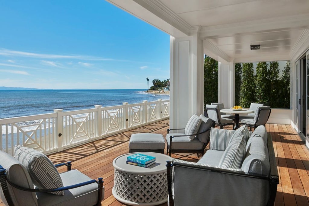 Luxurious terrace suite at Scenset Miramar Beach with panoramic ocean view, elegant outdoor seating, and contemporary coastal design in soft neutral tones