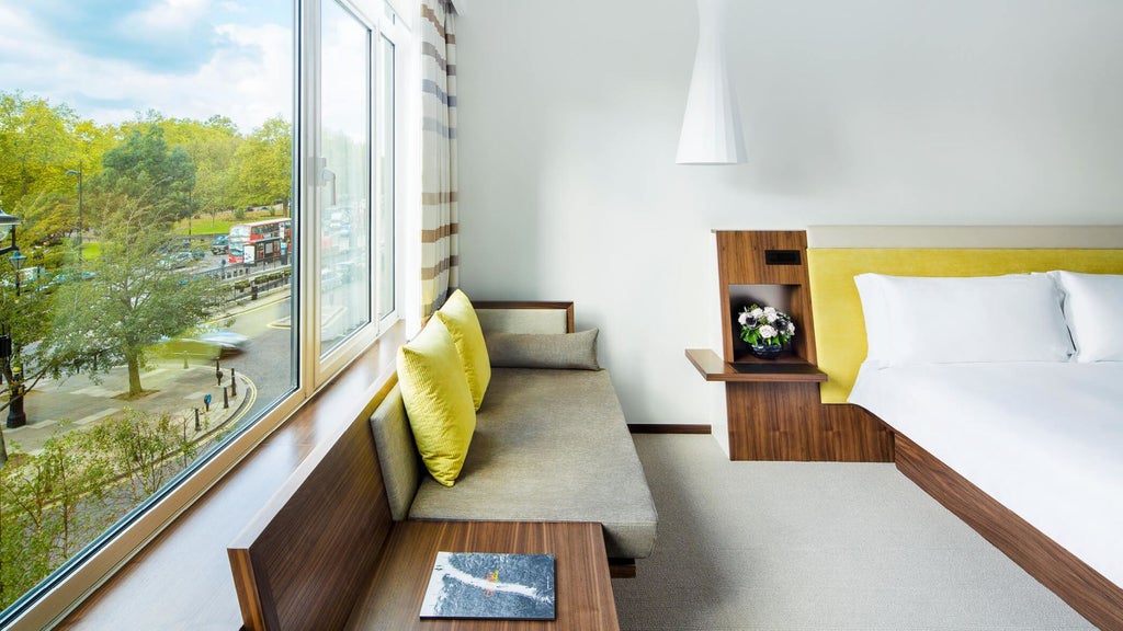 Elegant COMO Suite with plush white bedding, contemporary design, floor-to-ceiling windows overlooking urban London landscape, minimalist luxury decor
