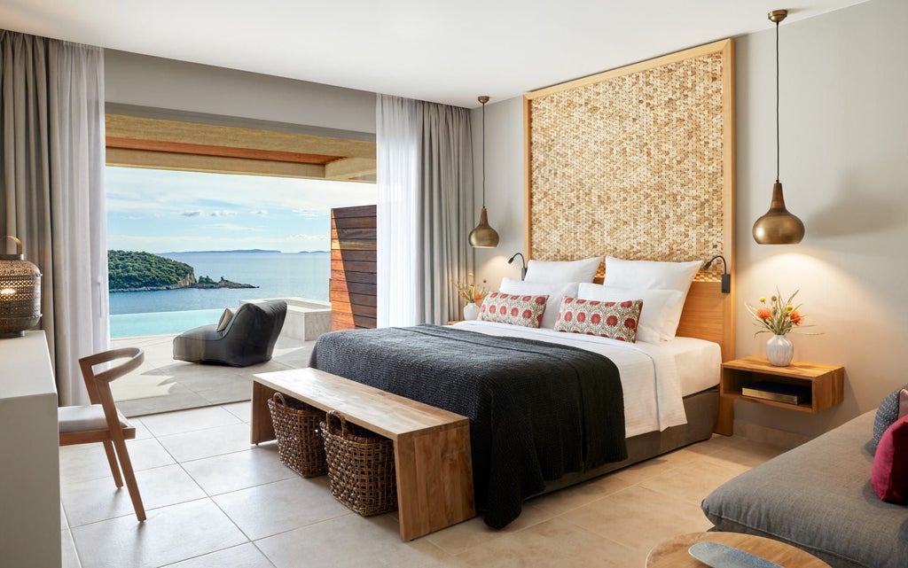 Luxurious deluxe hotel room with panoramic sea view, featuring a private pool, elegant decor, and contemporary Mediterranean design in Greece