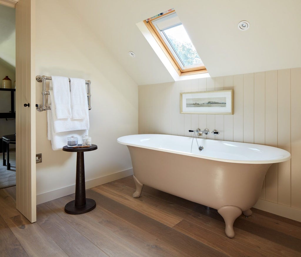 Elegant wood-paneled luxury suite with plush white bedding, antique furniture, and soft natural light at Grove of Narberth countryside retreat, showcasing refined British hospitality