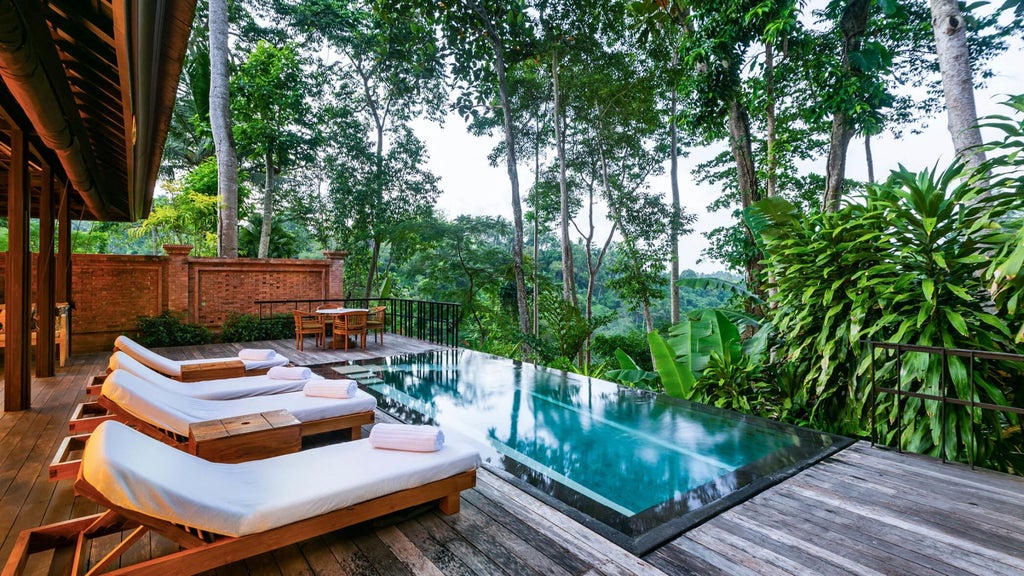 Luxurious villa suite with private plunge pool surrounded by lush Balinese jungle, featuring elegant outdoor terrace and local artwork