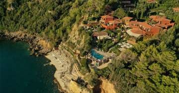 Luxury coastal hotel in Porto Ercole, Italy with terraced gardens, infinity pool overlooking Mediterranean Sea and stone architecture