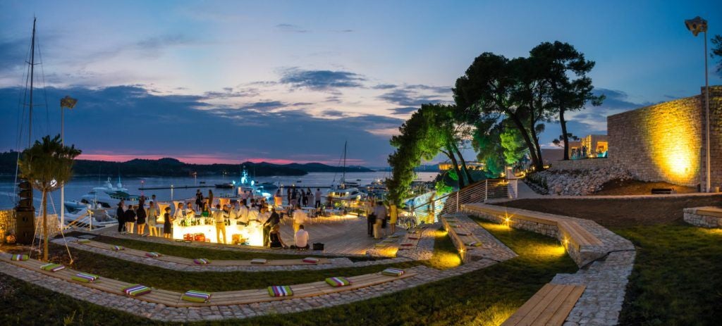 Luxurious seafront resort nestled on Croatian coastline, featuring modern architectural design with sleek white buildings and azure Adriatic Sea backdrop