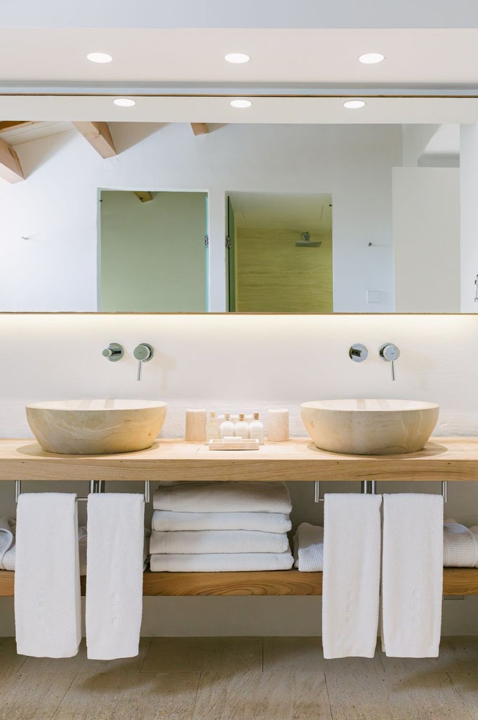 Rustic stone cottage with private garden, white-washed walls, and lavender details at Torralbenc luxury retreat in Spanish countryside