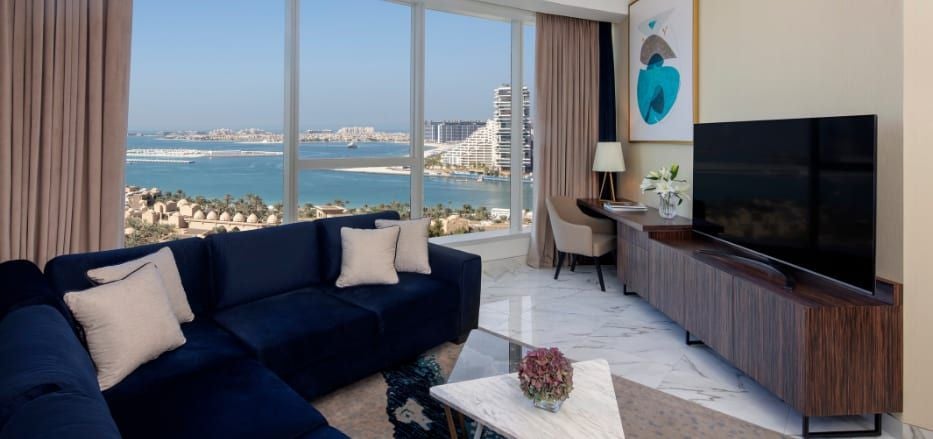 Spacious two-bedroom sea view apartment at Luxury Scenset+ Palm View Dubai Hotel, featuring modern decor, floor-to-ceiling windows, and stunning cityscape panorama