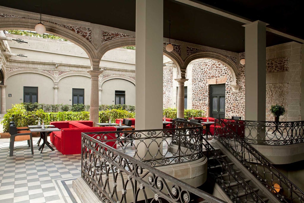 Opulent urban hotel lobby with colonial-era architectural details, ornate chandeliers, and rich leather seating in Mexico City's historic downtown district