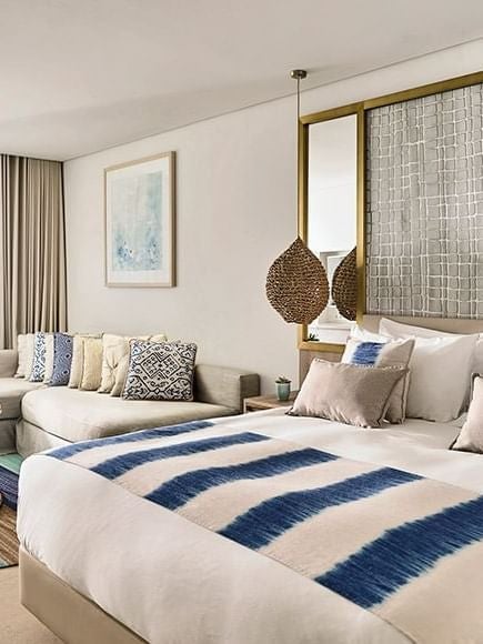 Luxurious junior suite with private plunge pool overlooking turquoise waters, crisp white furnishings, and elegant coastal design at Nobu Hotel Ibiza Bay