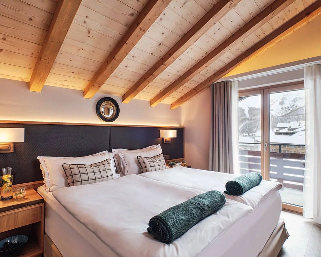 Luxurious Swiss Alps penthouse suite with panoramic mountain views, elegant contemporary design, and floor-to-ceiling windows showcasing alpine landscape