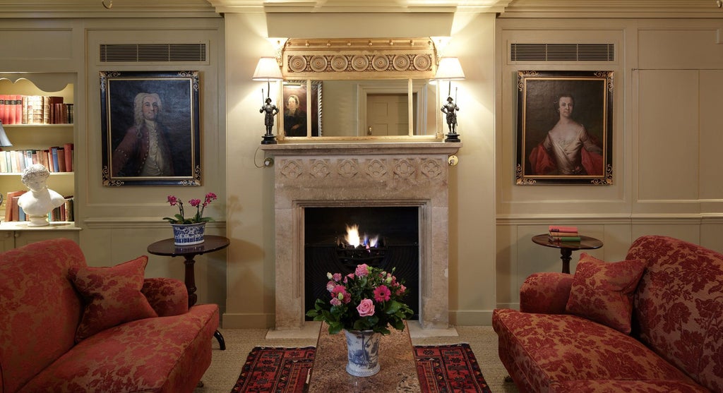 Elegant Georgian townhouse hotel with luxurious period furnishings, rich wood paneling, and ornate fireplace in historic London setting