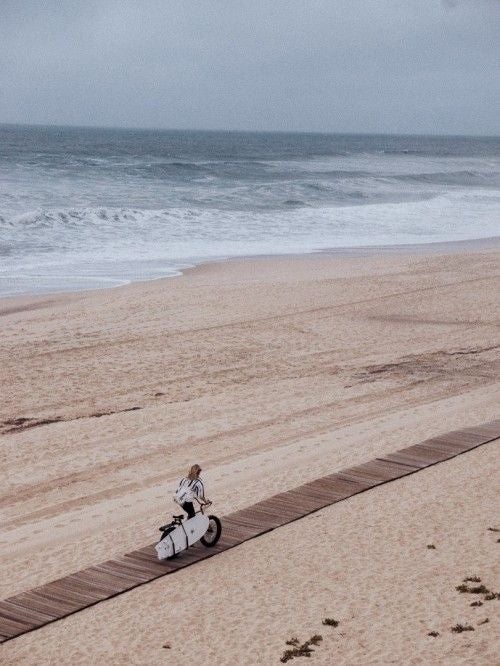 Minimalist beachfront hotel with sleek white architecture, wooden deck overlooking turquoise Atlantic waters, modern surfing lifestyle design in scenic coastal Portugal