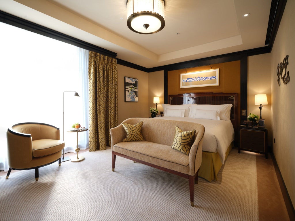 Elegant Premier Studio at Mayfair luxury hotel, featuring plush king bed, contemporary design, soft neutral tones, and refined city-view window with modern furnishings