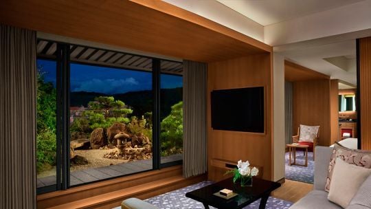 Elegant Ritz-Carlton Garden Terrace Suite overlooking tranquil Japanese garden with traditional design, sleek furniture, and panoramic city and mountain views