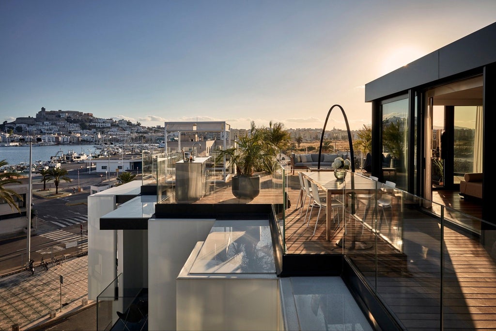 Minimalist white bedroom with sleek design, modern furniture, and large window overlooking urban landscape at contemporary boutique hotel in Spain