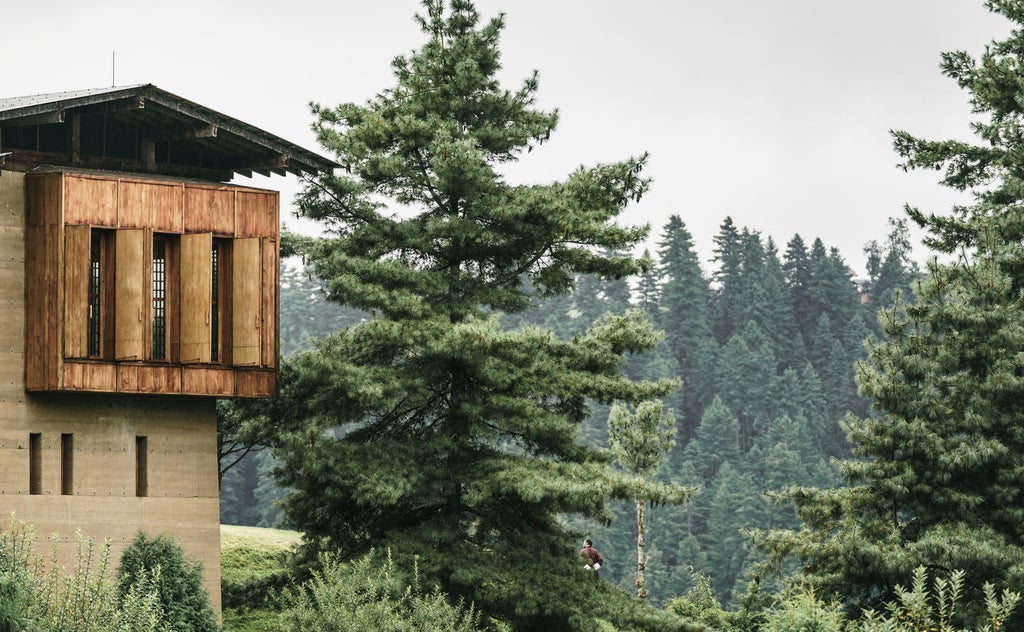 Luxurious mountain lodge with panoramic Himalayan views, featuring traditional Bhutanese architecture and floor-to-ceiling windows