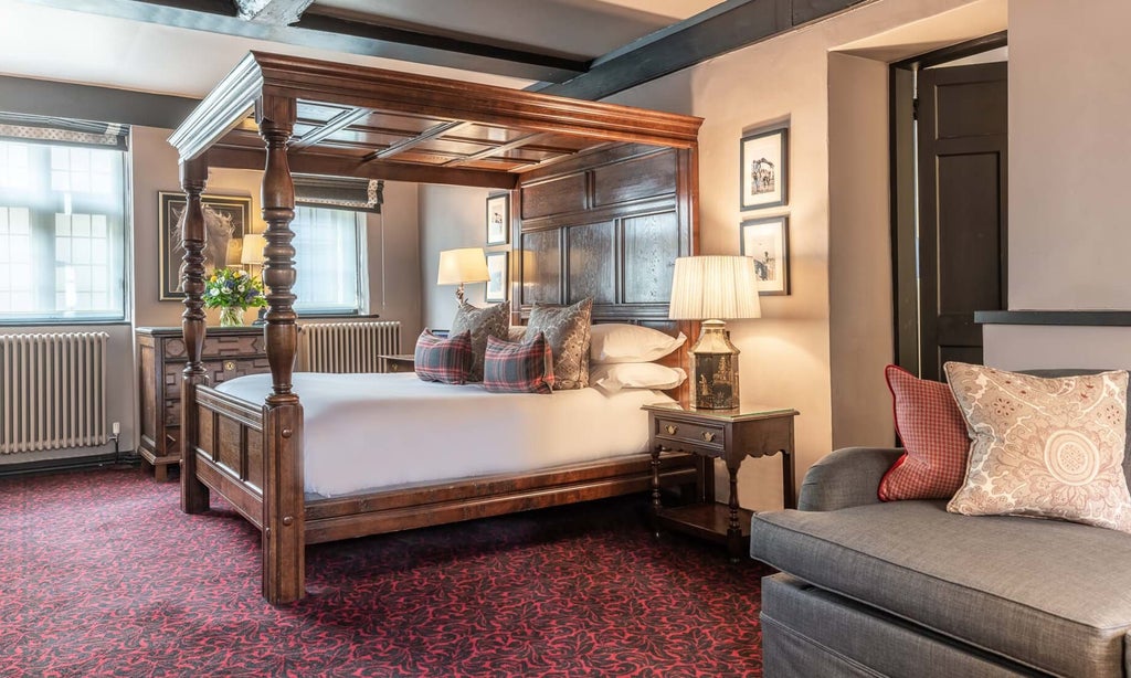 Elegant high-ceilinged superior room with classic British decor, wooden furnishings, soft neutral palette, and refined traditional hospitality ambiance at The Lygon Arms