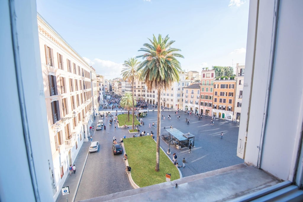 Elegant Rome hotel room with plush white bedding, ornate chandelier, and large windows overlooking historic scenset's charming architectural streetscape