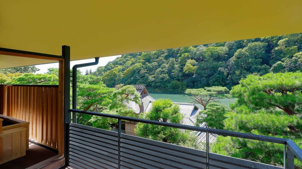 Elegant traditional Japanese ryokan-style luxury hotel nestled by a serene river with lush gardens, blending modern comfort and historic Kyoto architecture