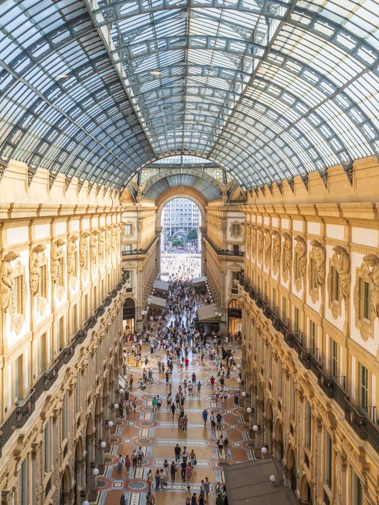 Luxurious presidential suite at Galleria Vik Milano with panoramic city views, elegant modern furnishings, and expansive windows showcasing Italian design excellence