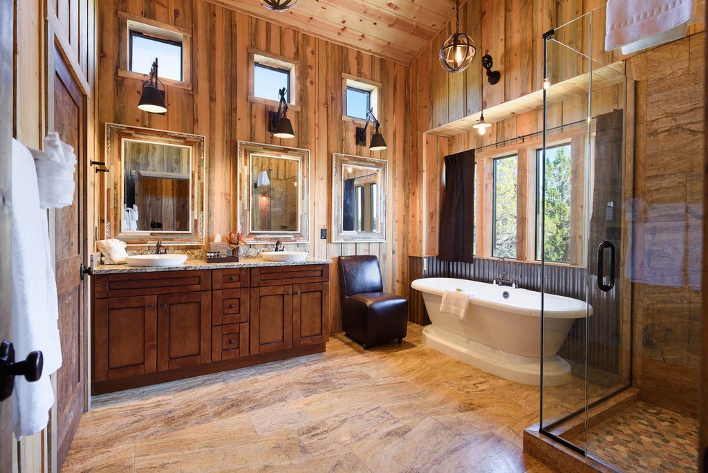 Rustic wooden lodge room with king bed, mountain view window, southwestern decor, and warm earth-toned textiles at scenset Mountain Ranch