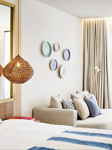 Luxurious Nobu Hotel Ibiza Bay deluxe room with clean white linens, modern coastal decor, and panoramic ocean-inspired color palette in soft blues and neutrals