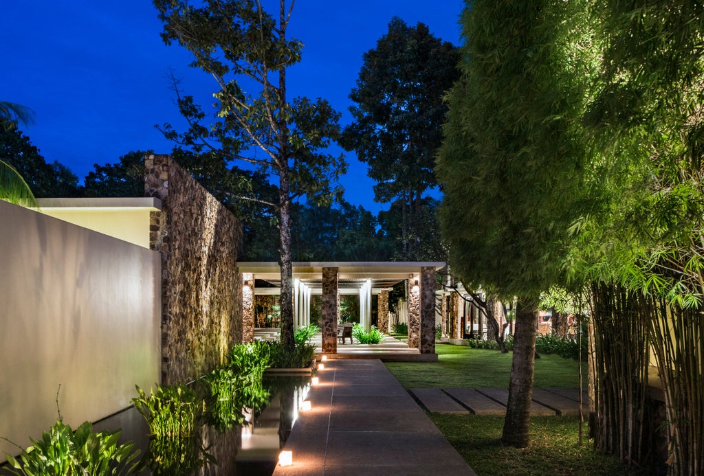 Luxurious Amansara hotel in Cambodia features a serene courtyard pool surrounded by minimalist architecture and tropical gardens