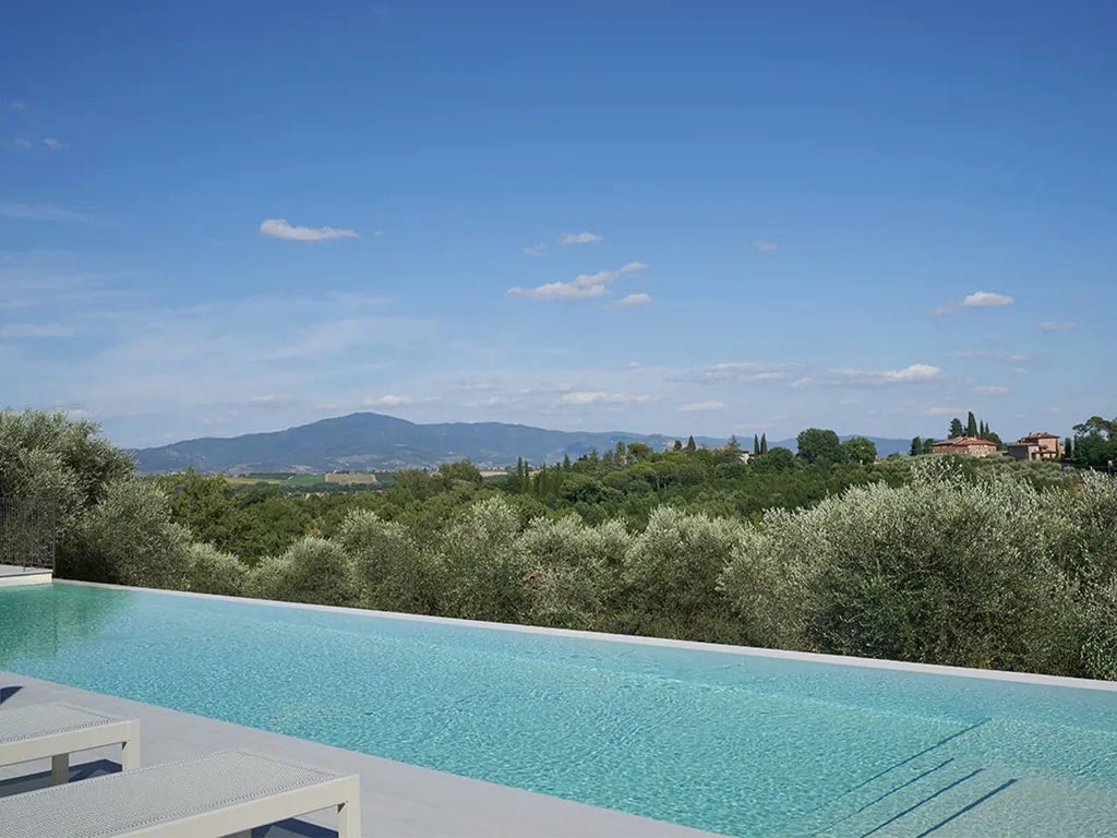 Luxurious stone villa with terracotta roof nestled in Tuscan countryside, surrounded by rolling green hills and cypress trees at golden hour