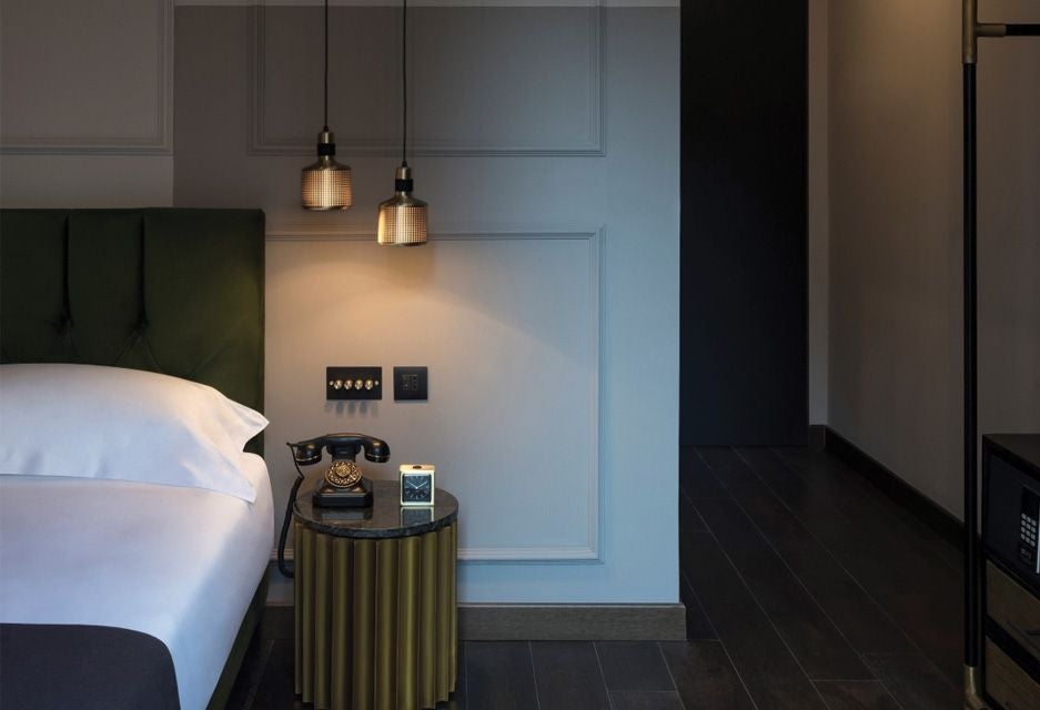 Minimalist modern hotel room with sleek Italian design, featuring neutral tones, elegant wood furnishings, and a carefully curated contemporary aesthetic at Chapter Roma.