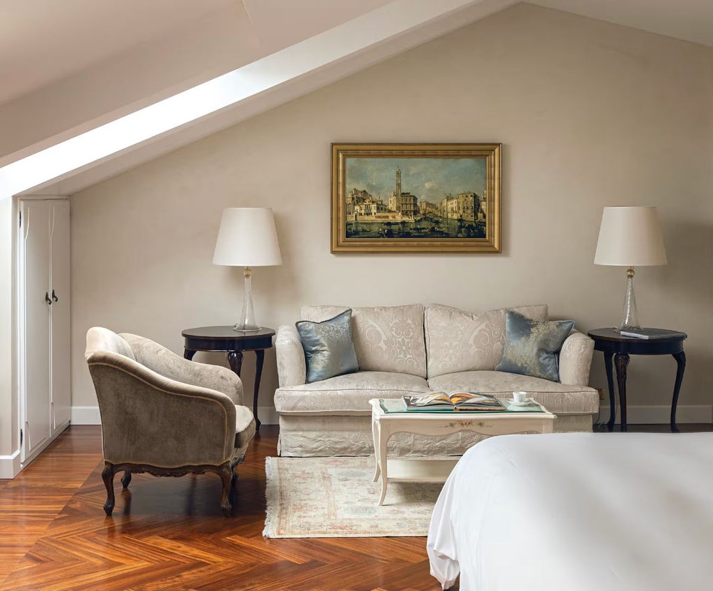 Elegant junior suite with private balcony overlooking Venice lagoon, featuring refined Italian decor, king bed and marble accents