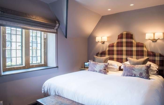 Elegant single room in The Lygon Arms' Main House, featuring traditional British decor with plush bedding, warm wood furnishings, and soft ambient lighting.