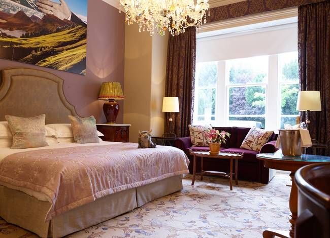 Elegant compact double hotel room with modern minimal design, soft neutral tones, plush bedding, and sleek wooden furnishings in United Kingdom boutique accommodation