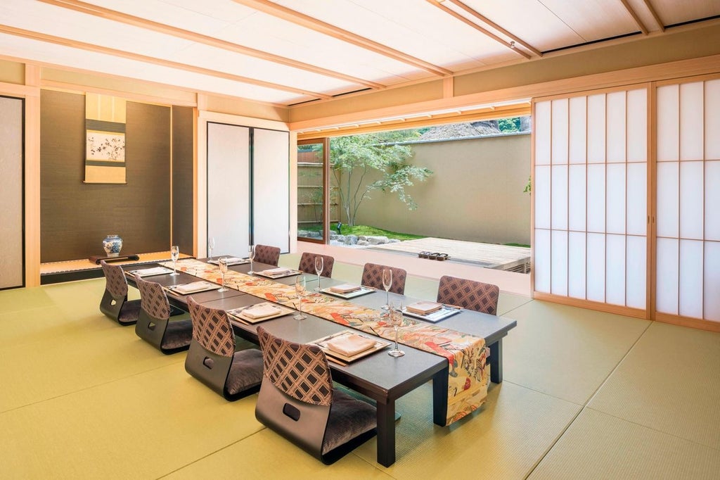 Elegant Japanese-inspired presidential suite with traditional tatami flooring, modern furnishings, and expansive city view of Kyoto's historic landscape