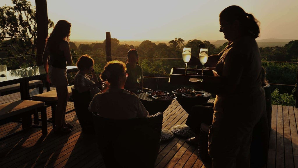 Luxurious safari tent interior at Galapagos Safari Camp, featuring elegant wooden furnishings, crisp white linens, and panoramic wilderness views of Ecuador's landscape