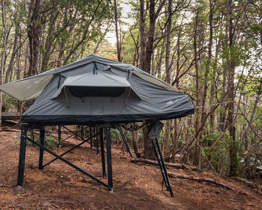 Luxurious premium camping accommodation at Hotel Las Torres Patagonia, featuring elegant interior with mountain-inspired decor and panoramic wilderness views of Chilean landscape