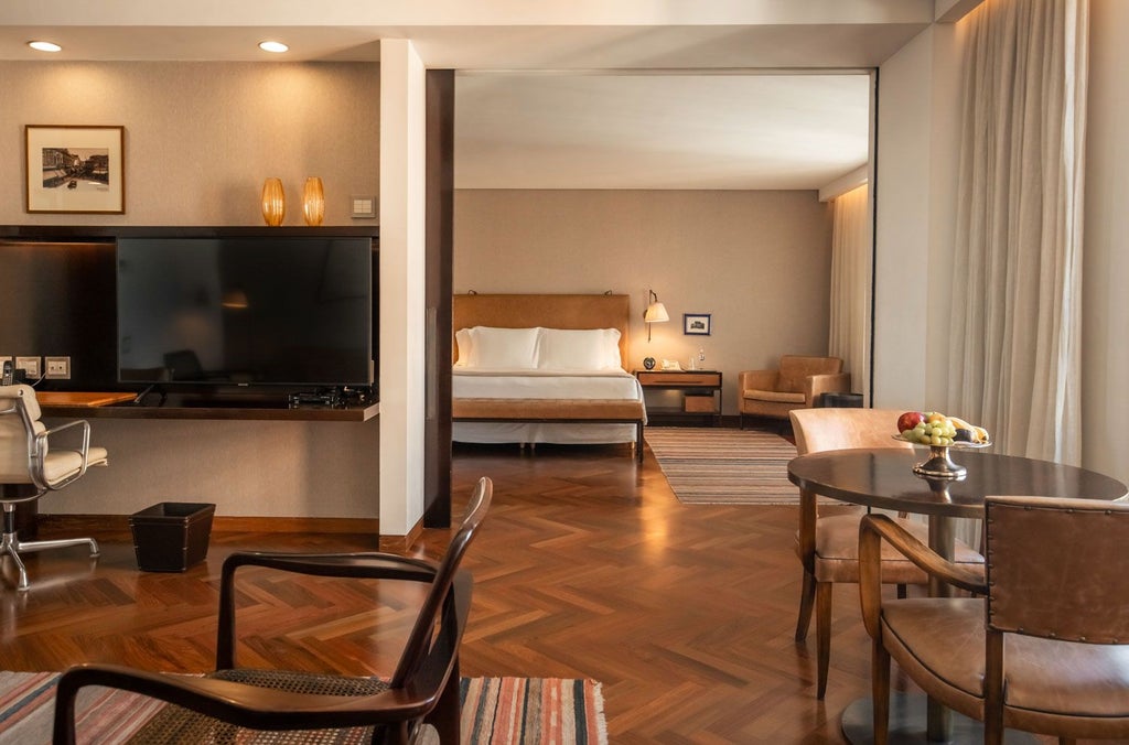 Luxurious hotel suite with panoramic city skyline, modern minimalist design, floor-to-ceiling windows, elegant neutral color palette, sleek furniture in Fasano São Paulo