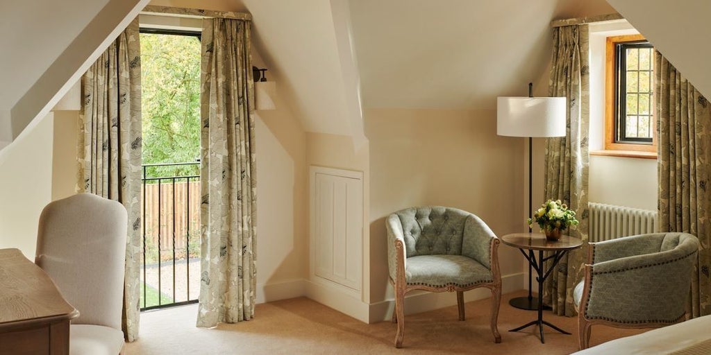 Elegant North Lodge suite at Coworth Park, featuring plush white bedding, soft natural light, and classic luxury design in a serene United Kingdom countryside setting