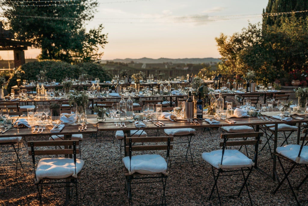 Elegant Italian villa-style hotel nestled on a sun-drenched hillside, featuring lush gardens, terracotta rooftops, and panoramic Mediterranean landscape view.