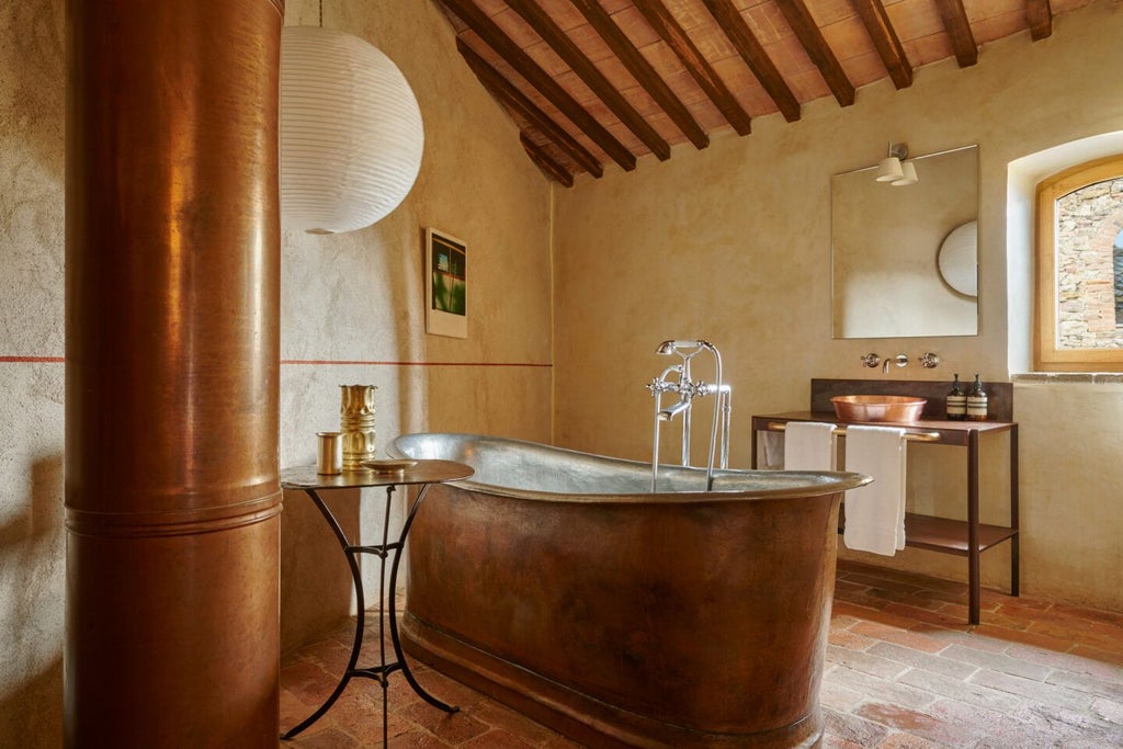 Rustic-chic suite with stone walls, elegant wooden furnishings, and panoramic Tuscan countryside views from a luxurious boutique hotel near Grosseto, Italy