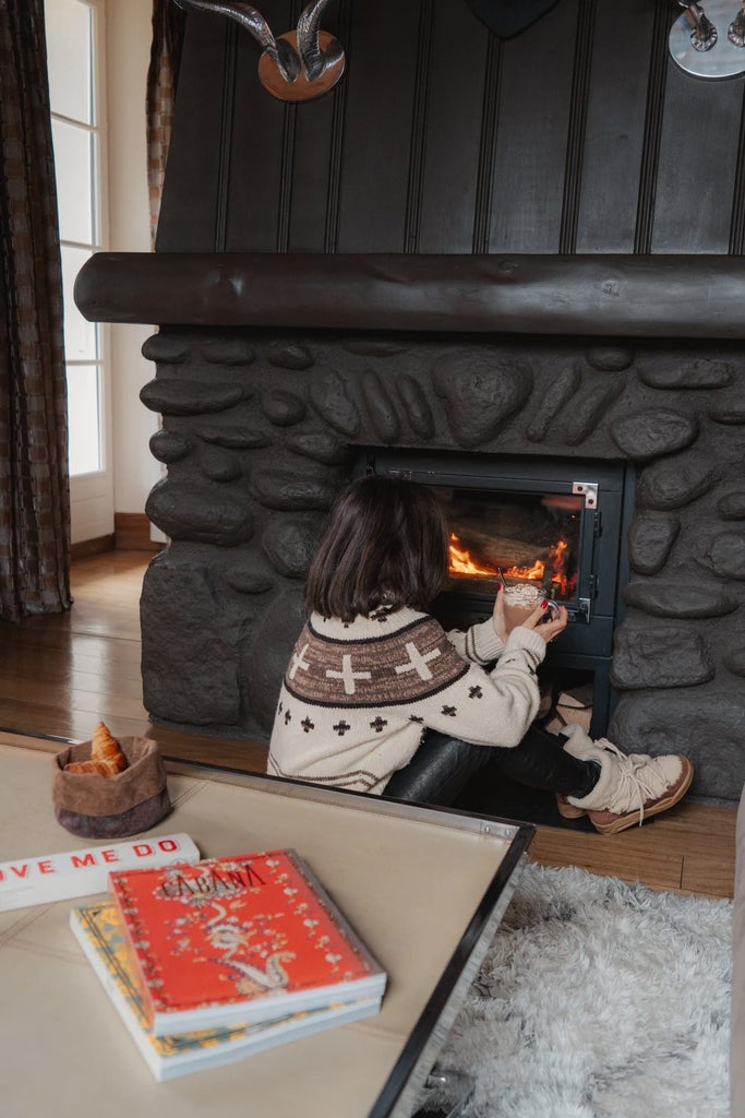 Luxurious wooden lodge hotel nestled in alpine forest, featuring rustic stone exterior, warm lighting, and elegant mountain retreat ambiance in scenic France.