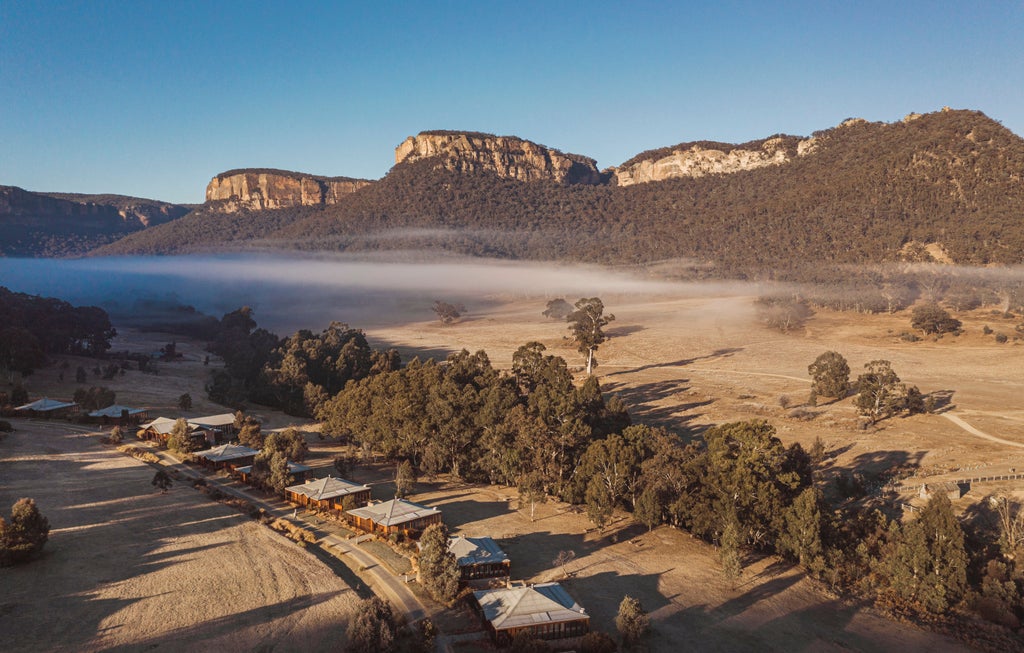 Luxurious stone villa with private infinity pool nestled in Wolgan Valley's mountains, surrounded by pristine Australian wilderness