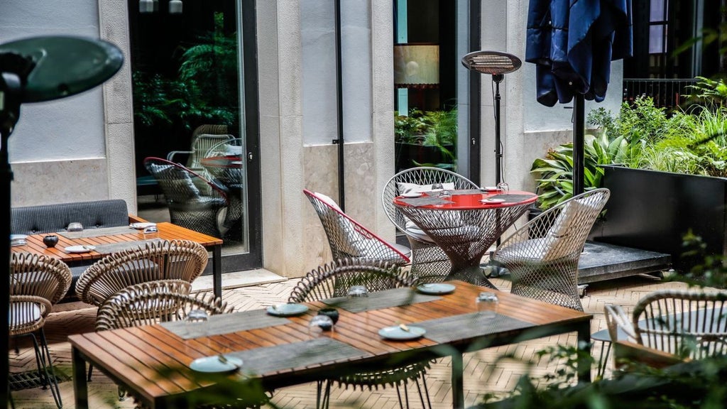 Elegant boutique hotel facade with lush garden, white exterior, and traditional Portuguese architectural details in Lisbon's historic district