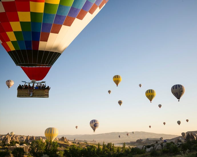 Rising out of the Cappadocia valley in hot air balloons