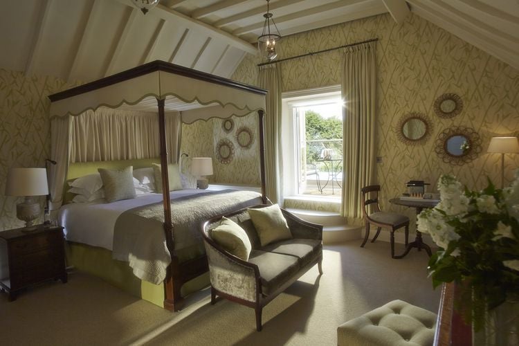 Elegant modern hotel room with plush white bedding, contemporary furnishings, soft neutral tones, and chic spa-like design at Dormy House Hotel & Spa