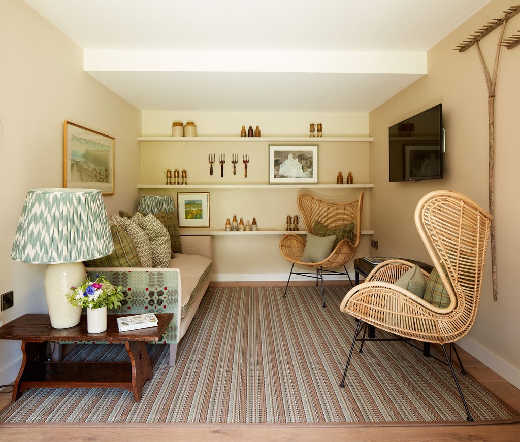 Elegant, rustic hotel room with soft green walls, plush white bedding, antique furniture, and natural light streaming through large windows overlooking lush countryside