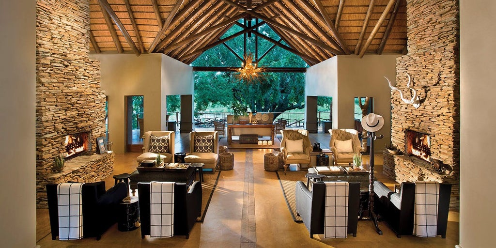 A luxury safari lodge with private deck overlooking Kruger National Park, featuring plunge pool and contemporary African decor